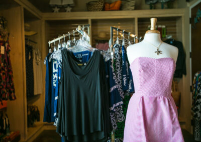 Women's mannequin wearing gingham checked dress and starfish necklace.